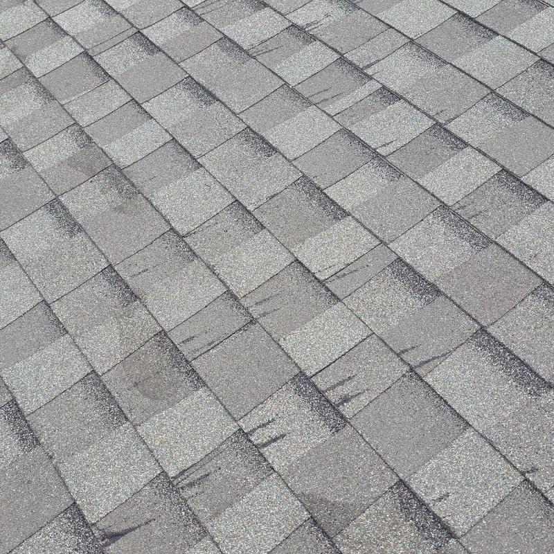 Asphalt shingles with hail damage marks on roof