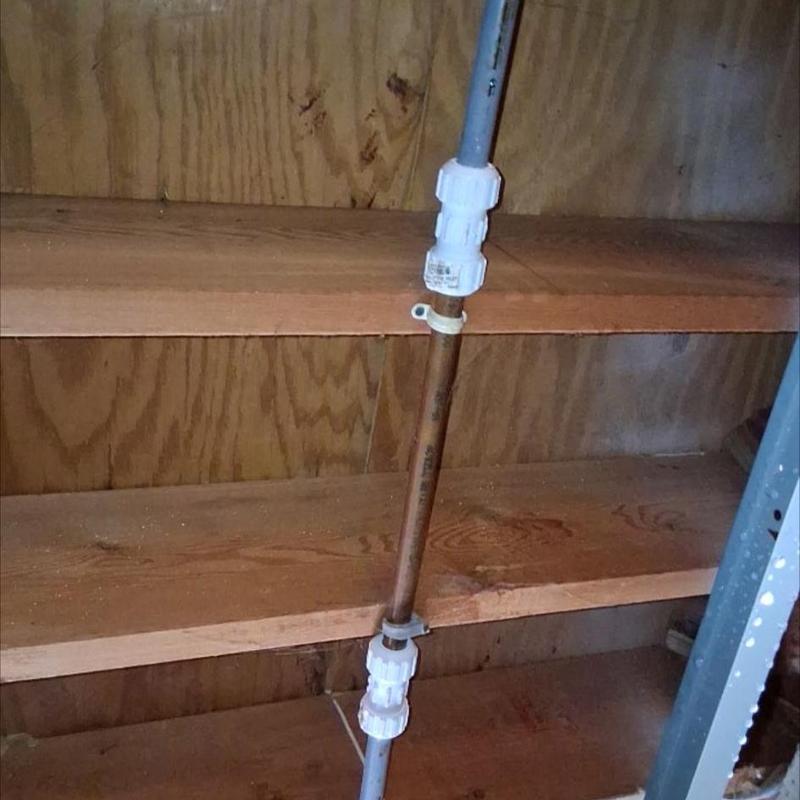 Copper pipe with union fittings inside wall cavity