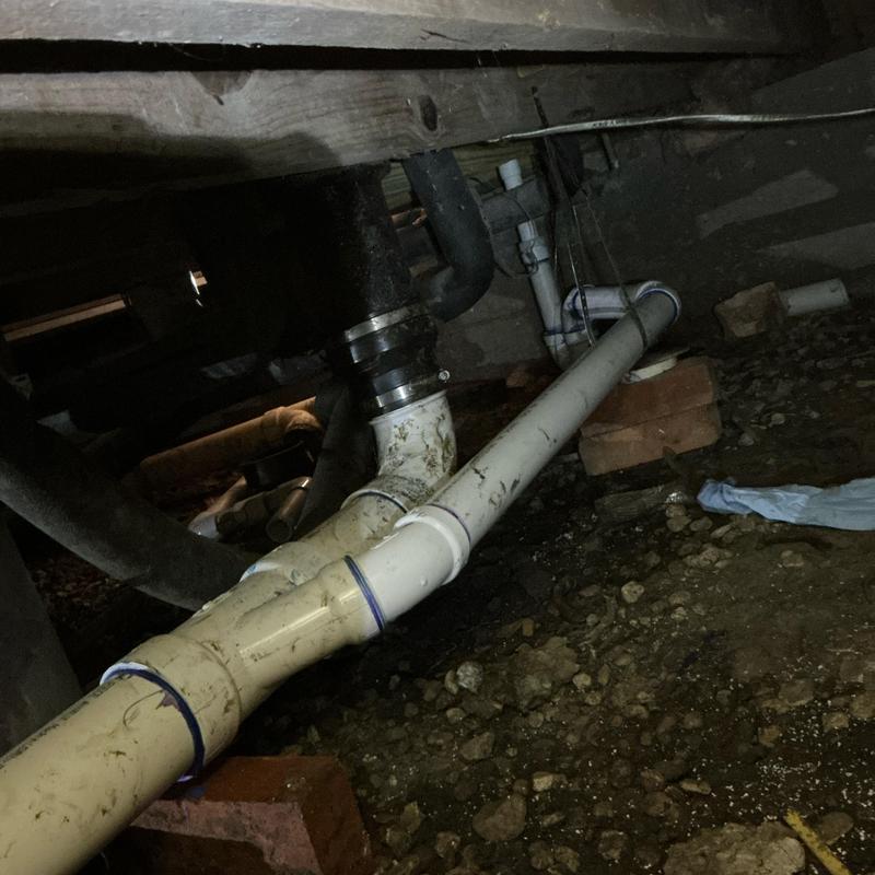 PVC drain pipe with proper hangers and fall in crawl space PVC drain pipe with proper hangers and fall in crawl space