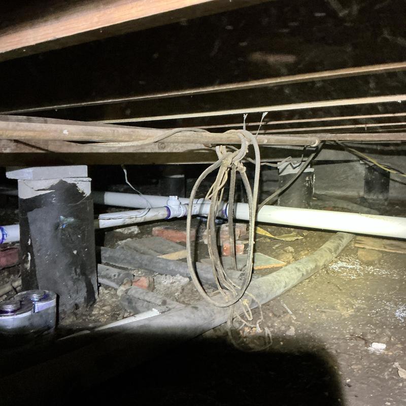 PVC drain pipe with new hangers in crawl space PVC drain pipe with new hangers in crawl space