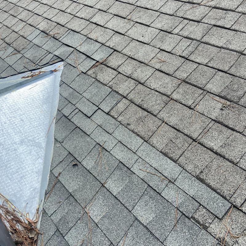 Asphalt shingles roof inspection near skylight panel