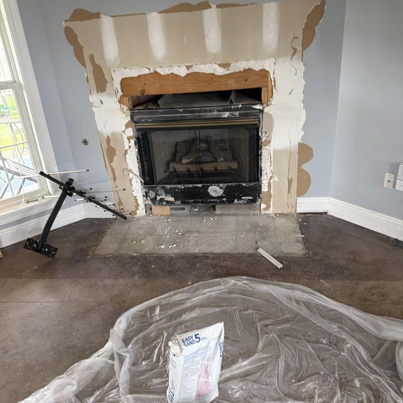 Fireplace drywall repair with plaster and sanding tools