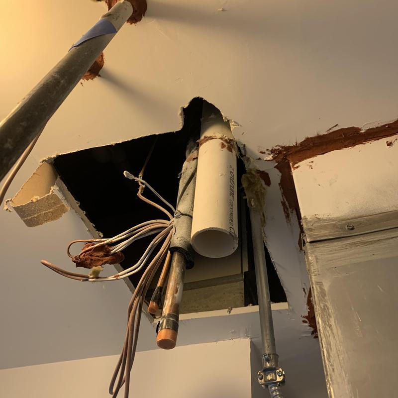Gas furnace exhaust pipe and thermostat wiring in ceiling hole