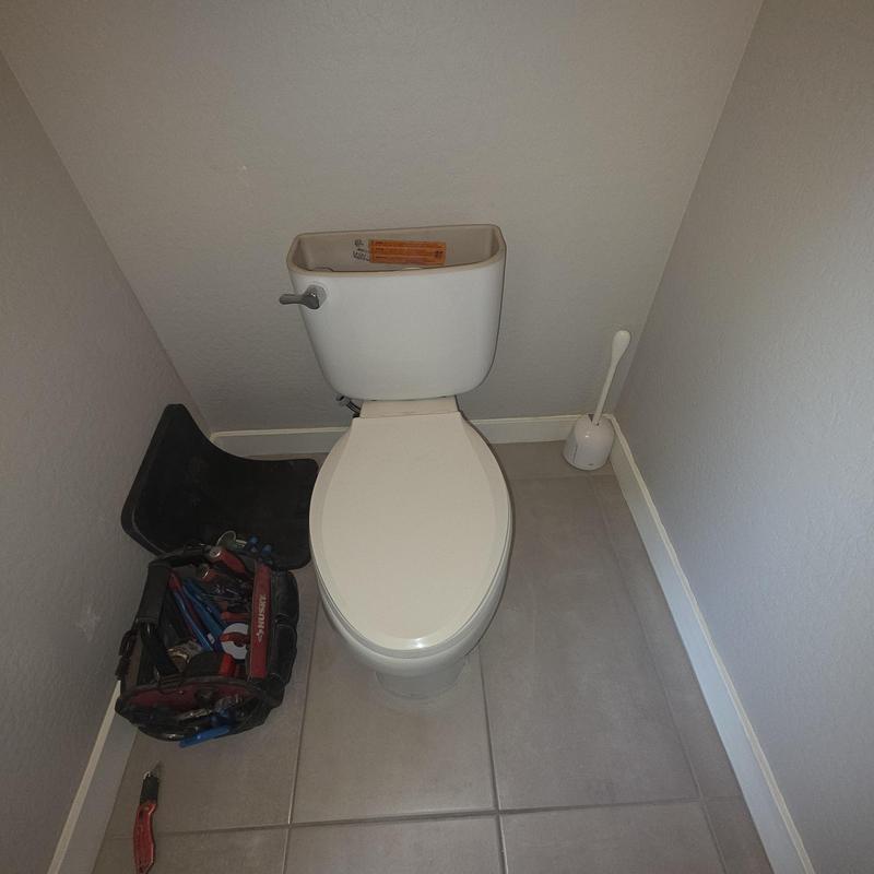 Customer provided toilet installation with plumbing tools nearby