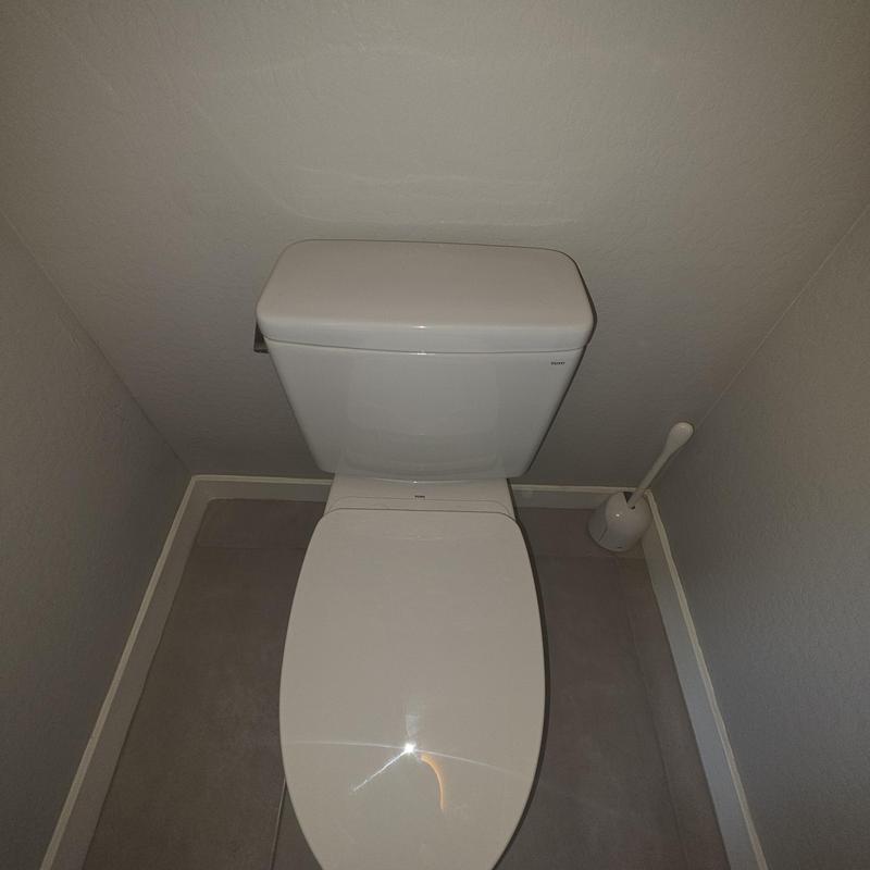 Toilet installation in a small bathroom corner
