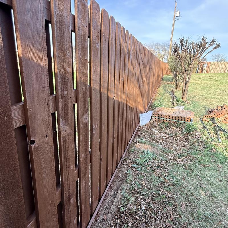 Wood fence with Sherwin Williams stain in yard