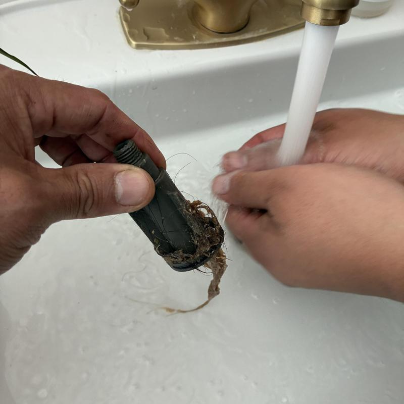 Bathroom basin drain hair clog removal under running water