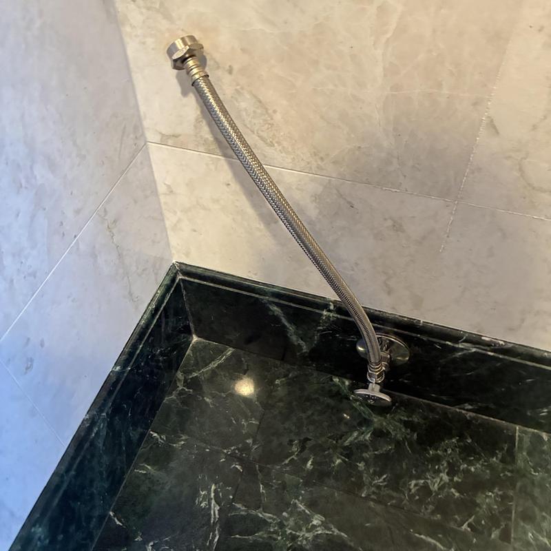 Flexible toilet water supply line installation on marble floor