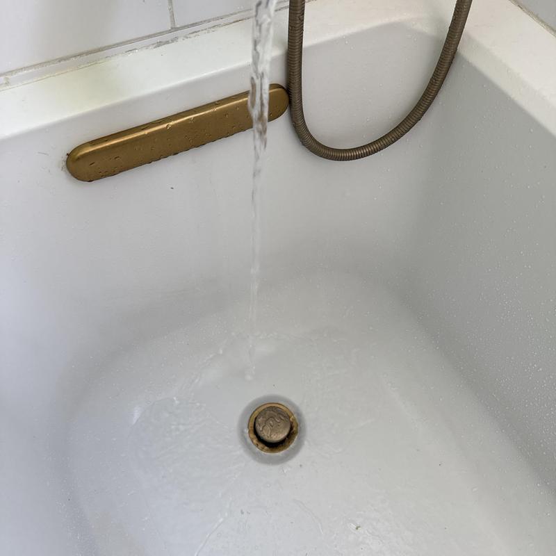 Bathtub drain with water flowing after blockage removal