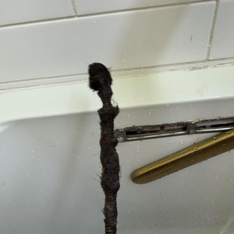 Bathtub drain clog removal with hand crank snake