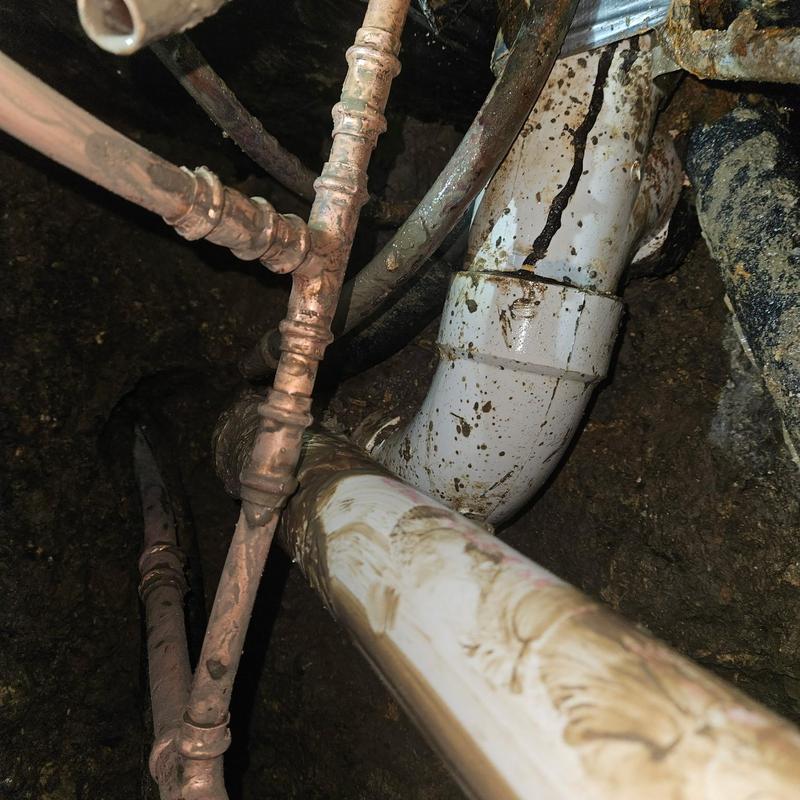 Copper manifold and PVC pipes under slab with soil