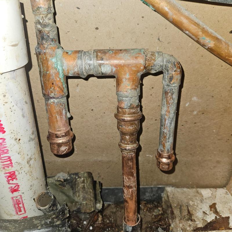 Copper plumbing manifold with water corrosion and buildup