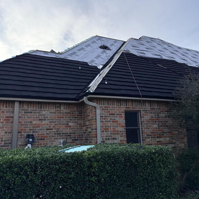 Stone coated steel roof installation in charcoal color