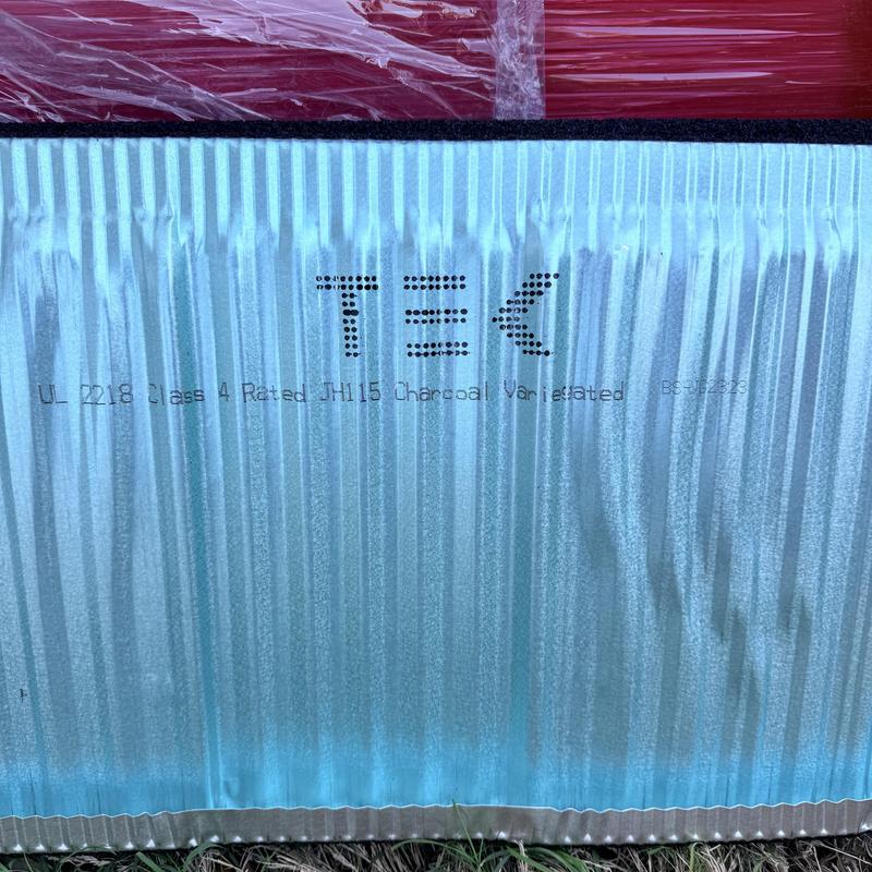 Stone coated steel roof panel close-up in charcoal color