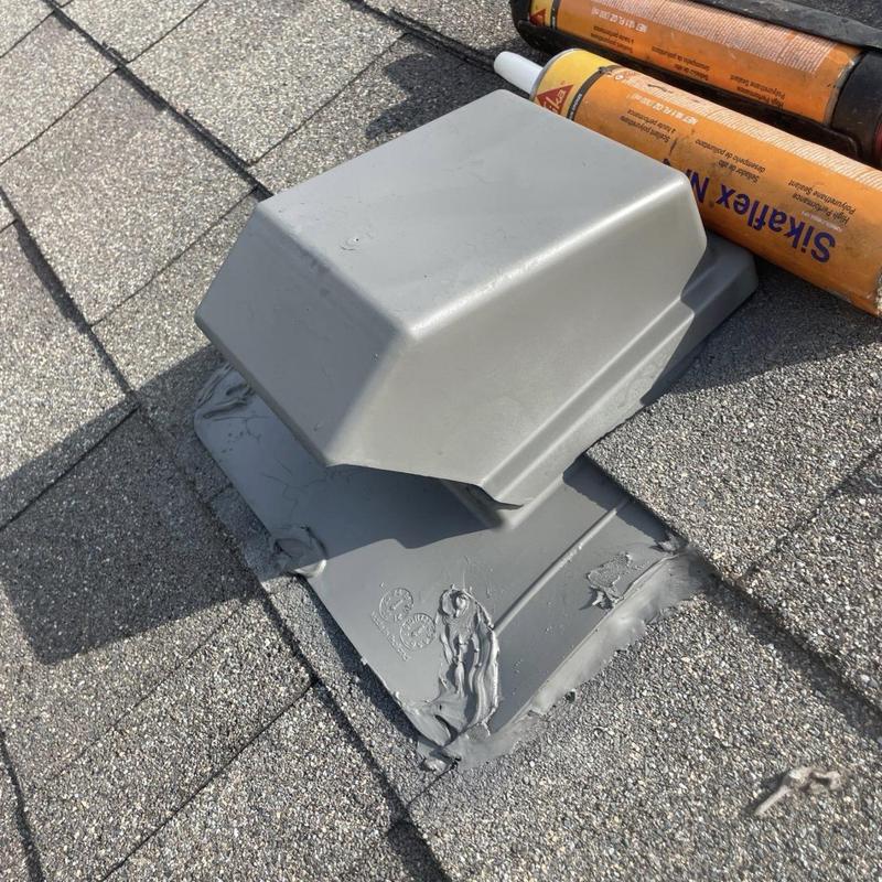 Roof vent with sealed flashing on asphalt shingles