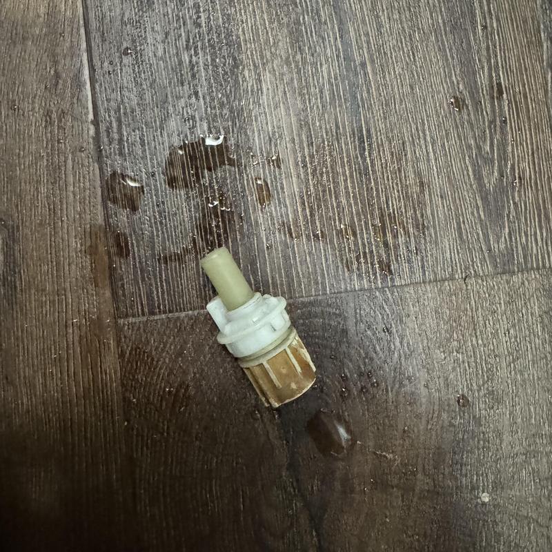 Shower cold side cartridge with water droplets on floor