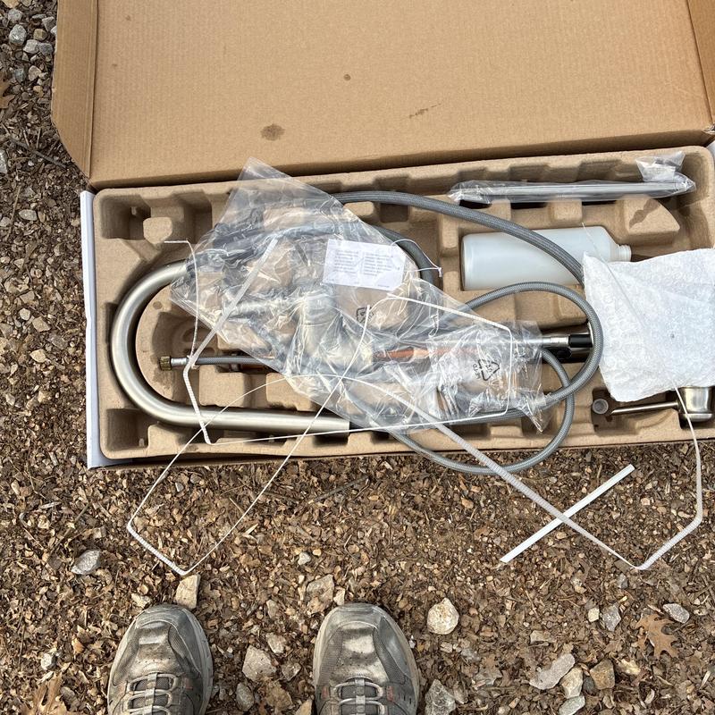 Kitchen faucet components in packaging ready for installation