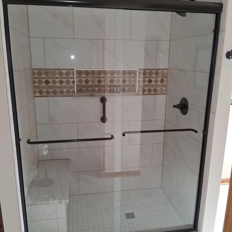Custom glass shower door with tile surround installation