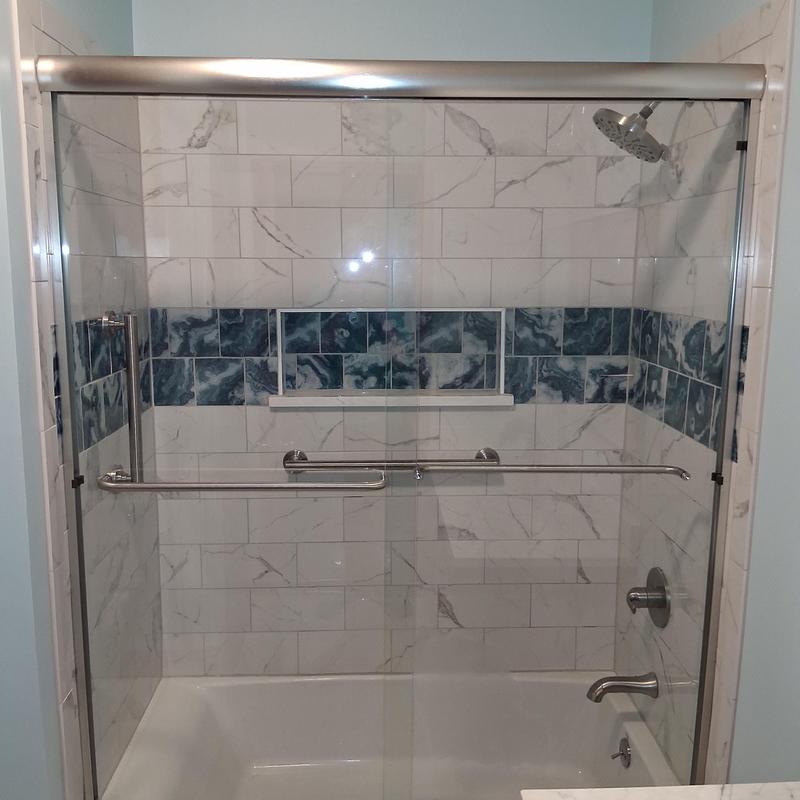 Glass shower door with tile wall installation