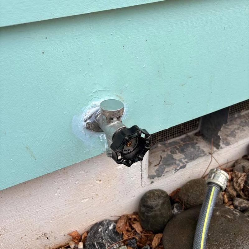 Exterior frost-free hose bib installation on siding wall