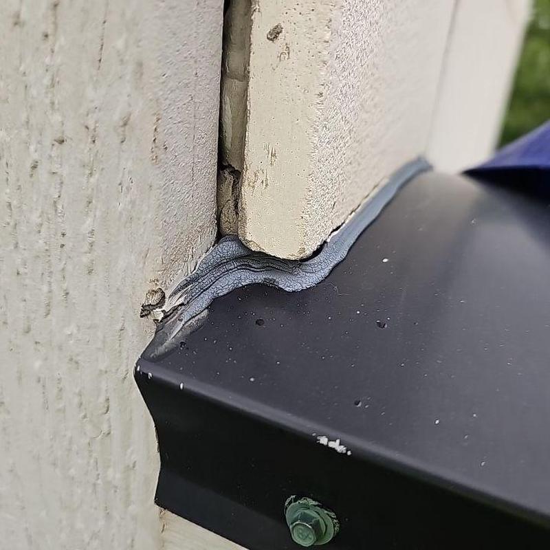 Siding resealing at patio roof edge with caulking Siding resealing at patio roof edge with caulking