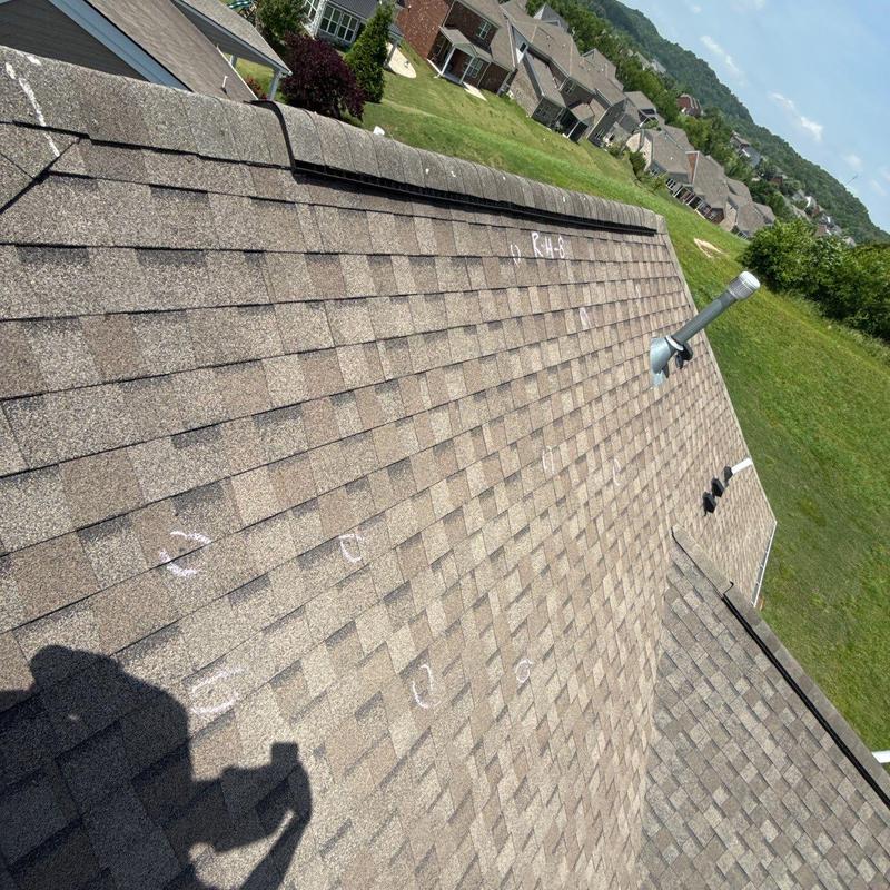 Asphalt shingle roof with marked hail damage inspection