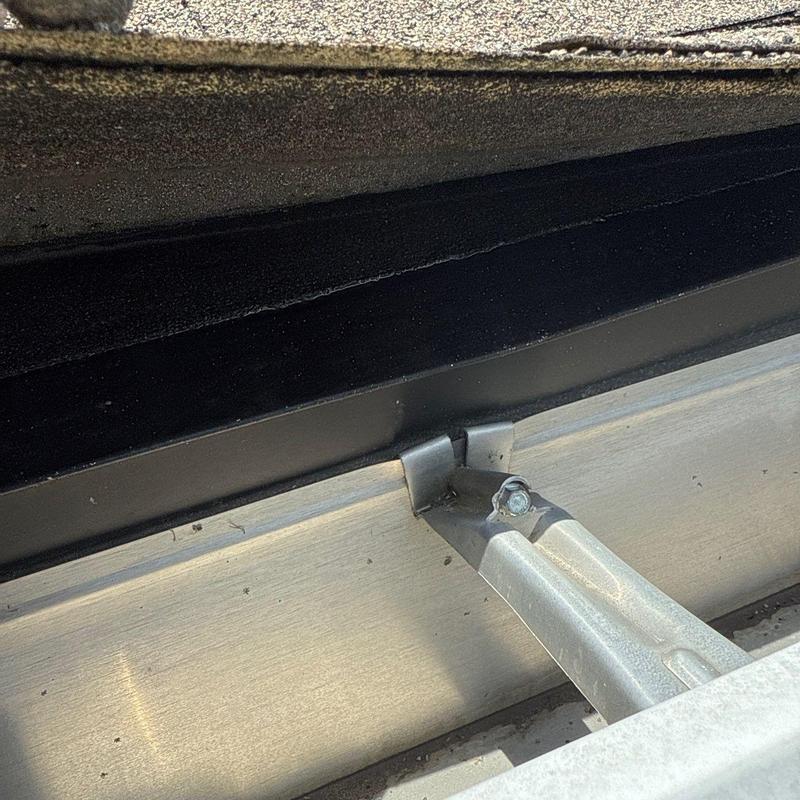 Roof edge flashing and metal support bracket close-up