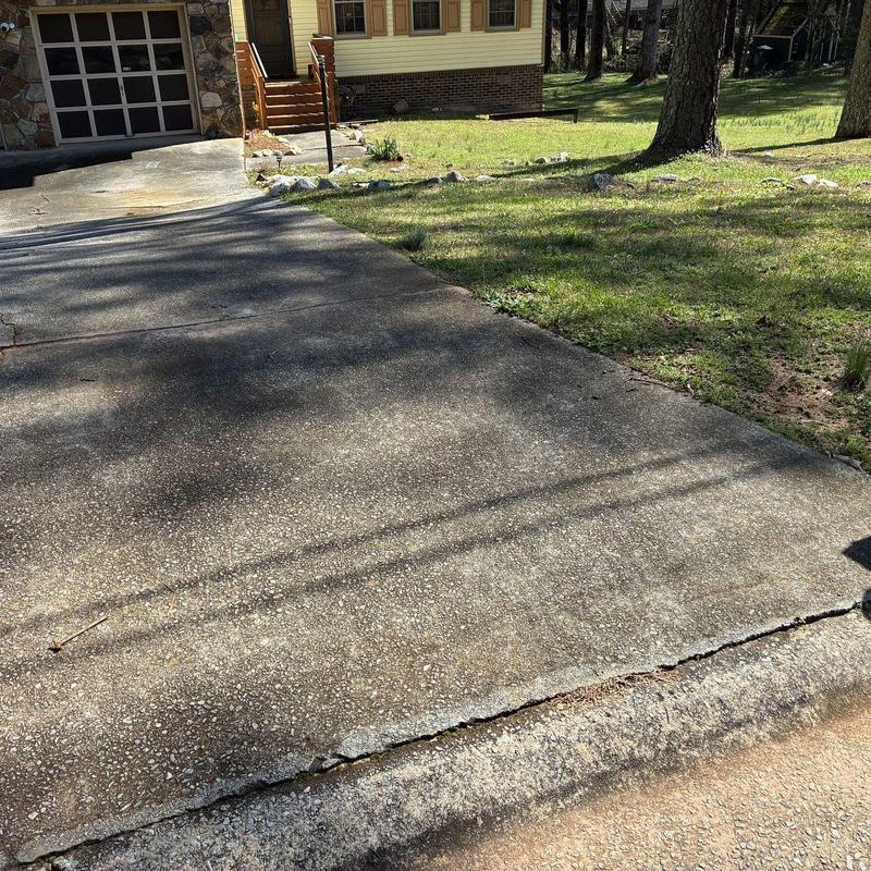 Concrete driveway with cracks and uneven edges