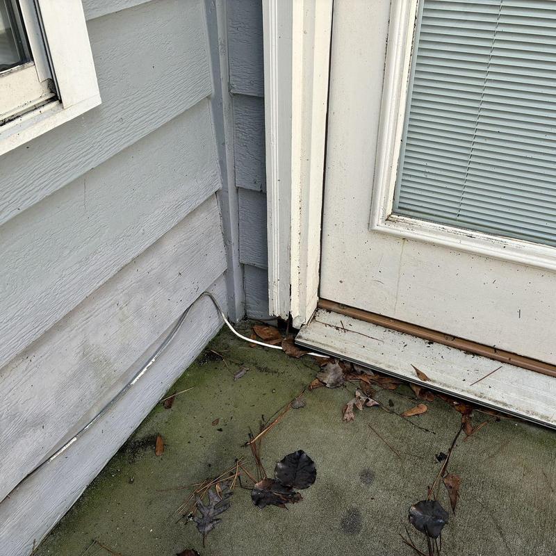 Siding and door trim corner with weather damage