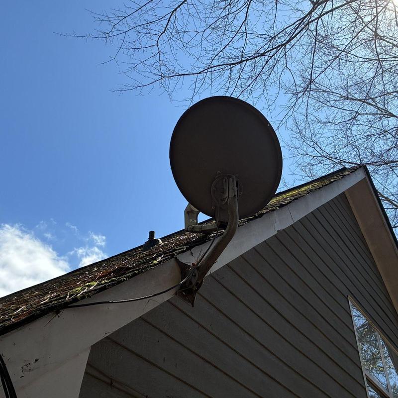Satellite dish mounting on roof fascia and siding