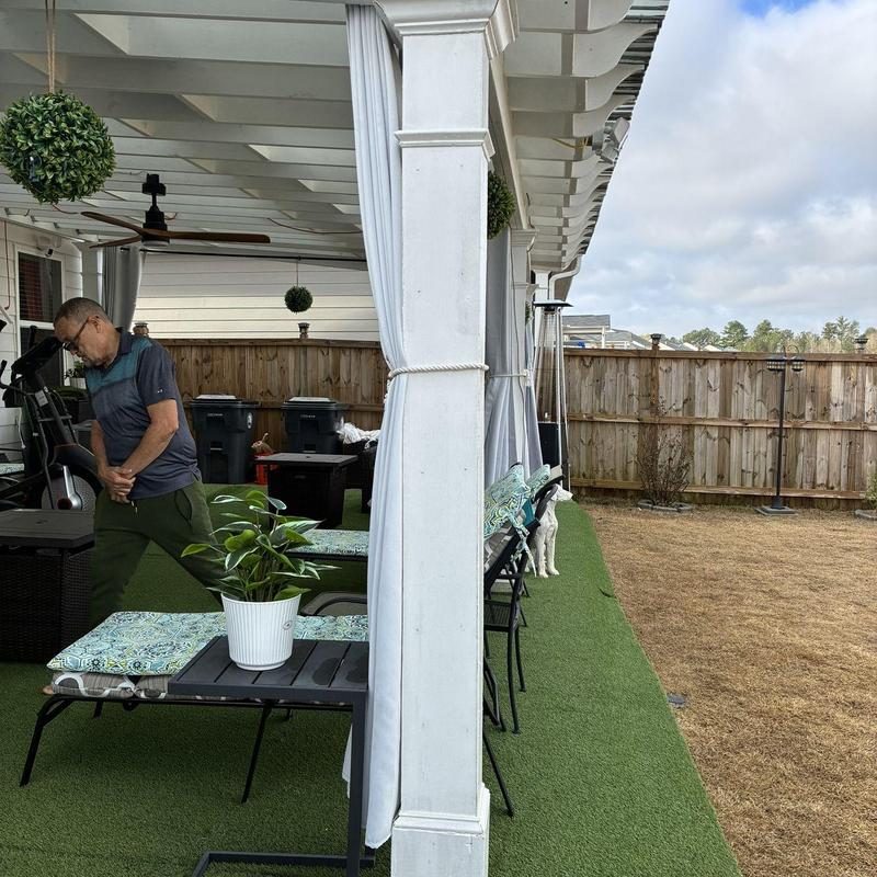 White pergola with translucent roof and curtains