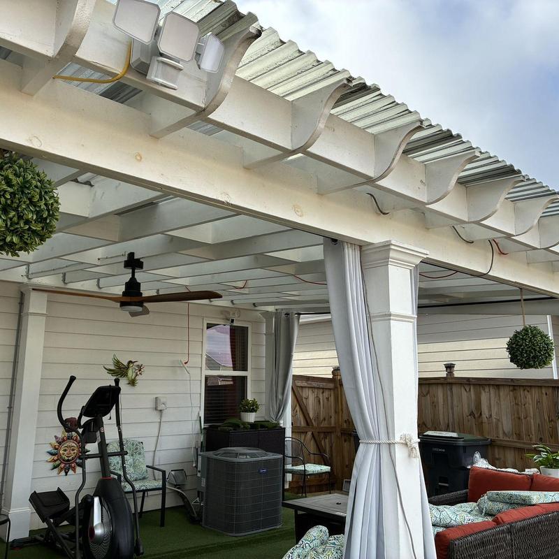 Corrugated translucent pergola roof with columns and curtains