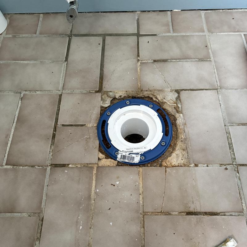 Toilet flange installation on tiled bathroom floor