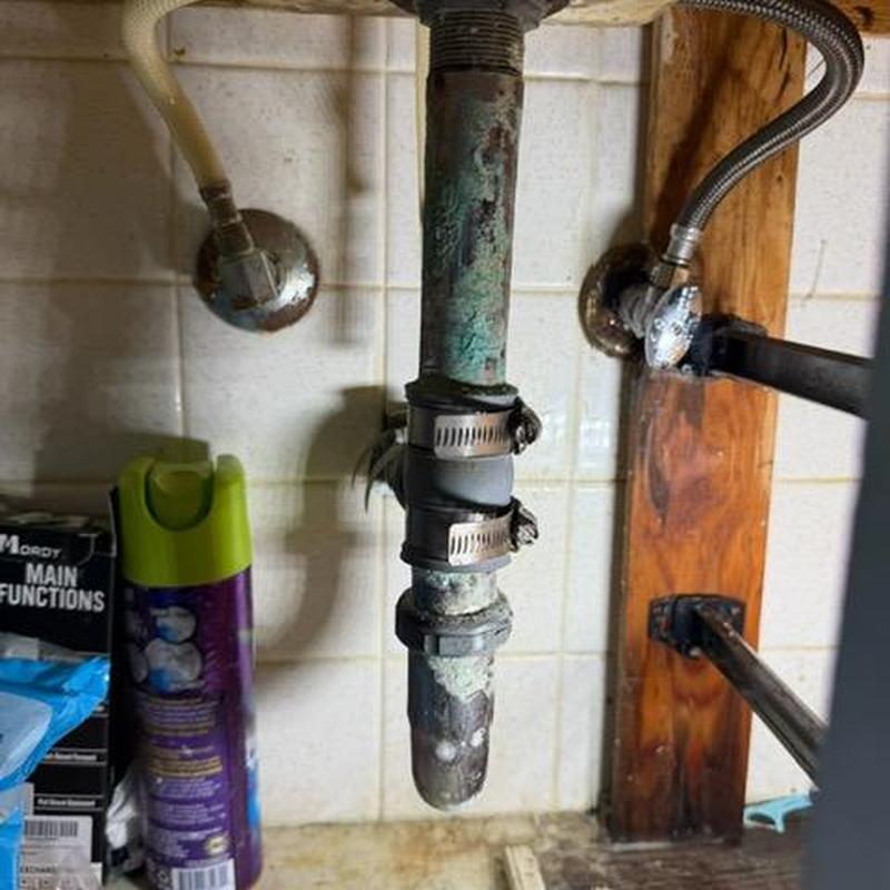 Sink drain pipe with repair clamps and corrosion