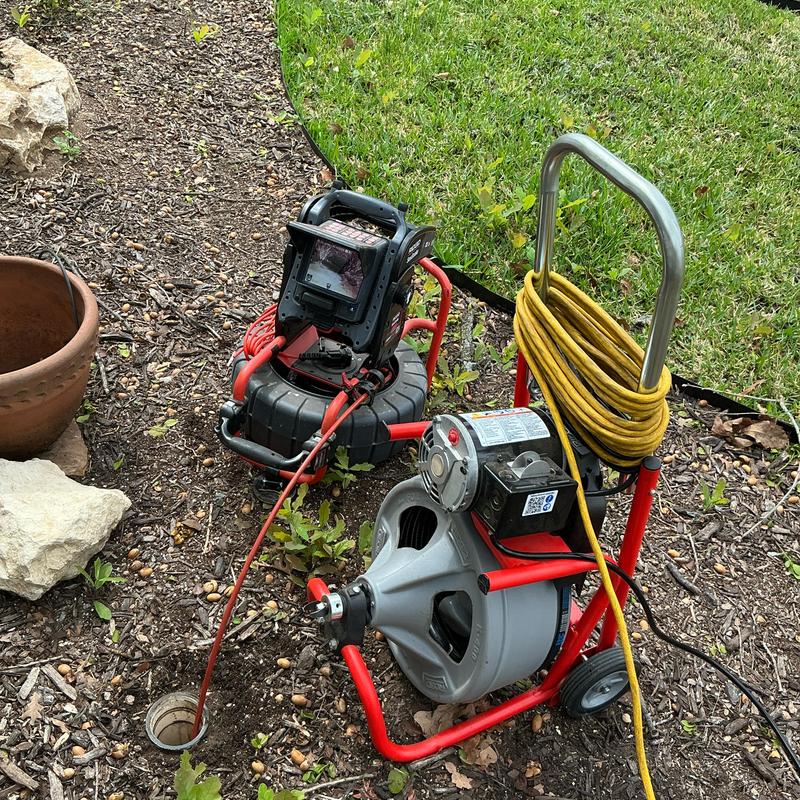 Sewer drain clog camera and cleaning machine setup outdoors