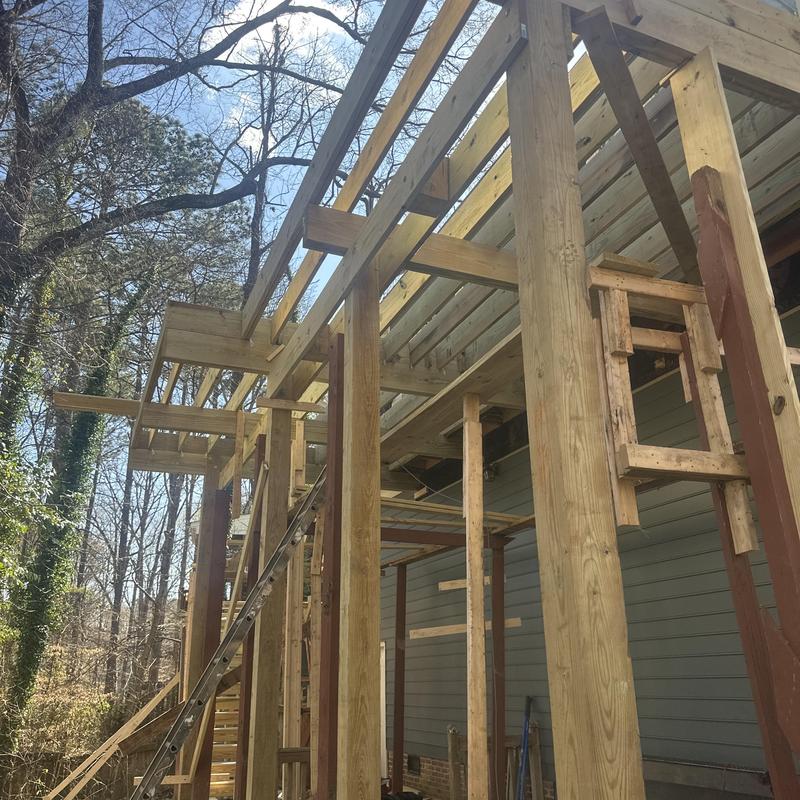Sunroom framing with support beams and ladder