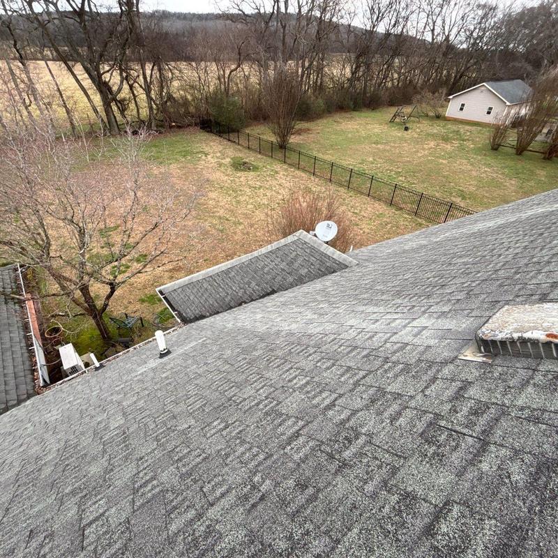 Roof shingles with wear and damaged areas on residential roof