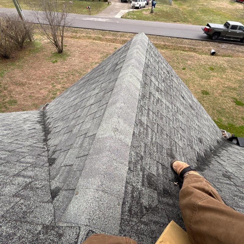 Roof ridge and shingles inspection on residential roof