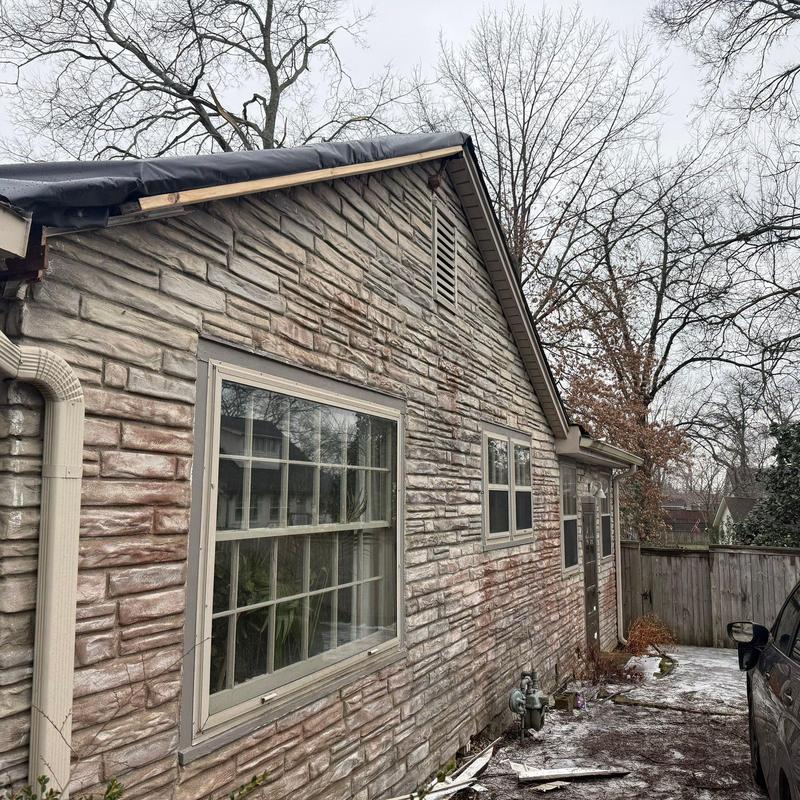 Roof edge with storm damage and gutter inspection in progress