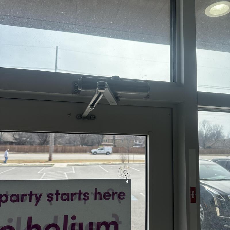 Automatic door closer on commercial entry door