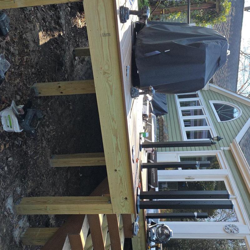 Wood deck framing with posts and joists in progress