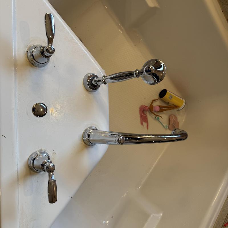 Roman tub faucet with handles on bathtub edge