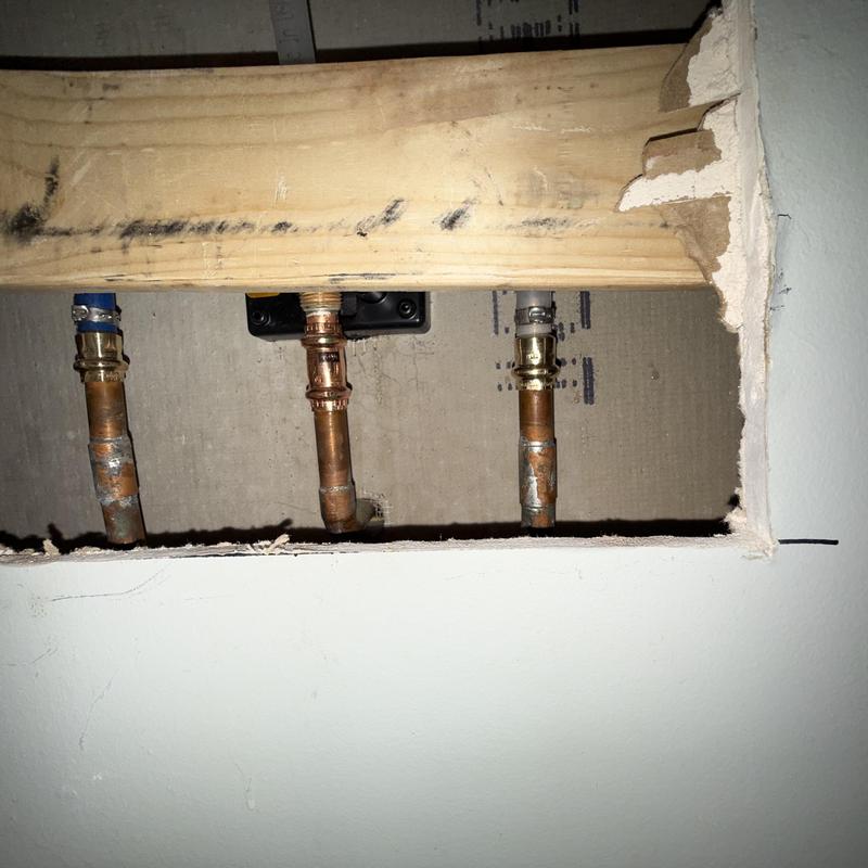 Copper plumbing pipes rough-in inside wall cavity