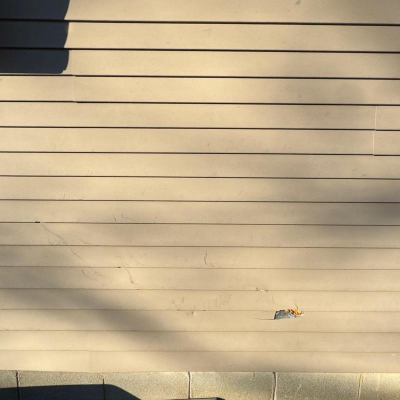 Vinyl siding with minor dents and damage close-up
