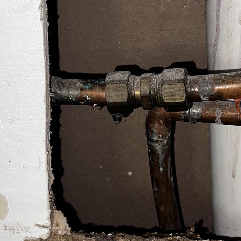 Copper water pipe leak with fittings and corrosion damage
