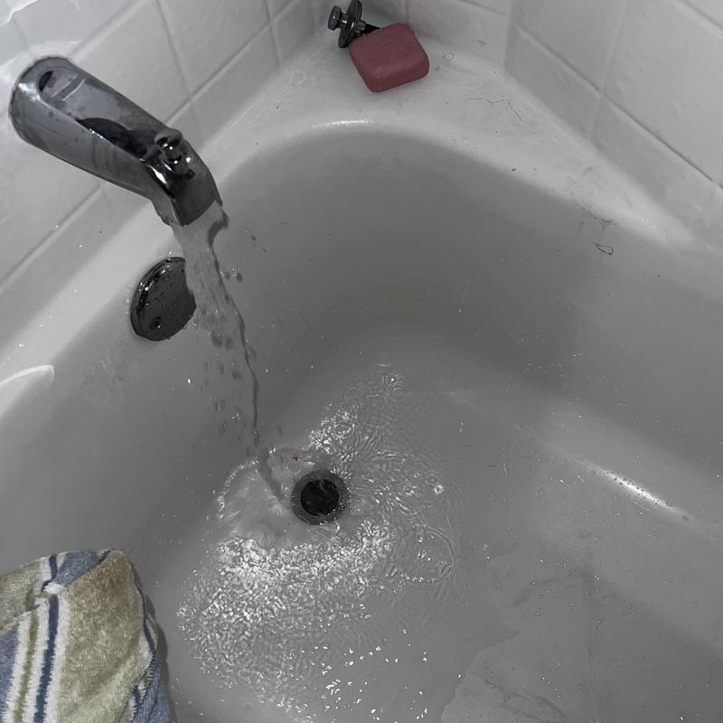 Bathtub drain clearing with flowing water and soap bar