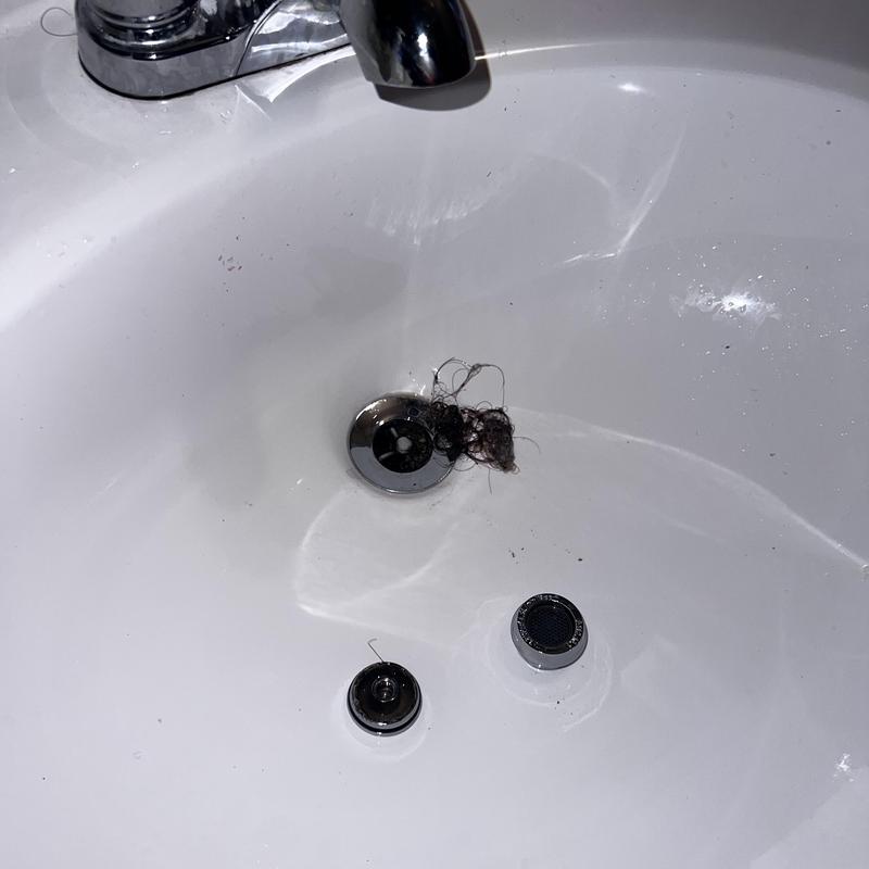 Bathroom sink drain clogged with hair blockage