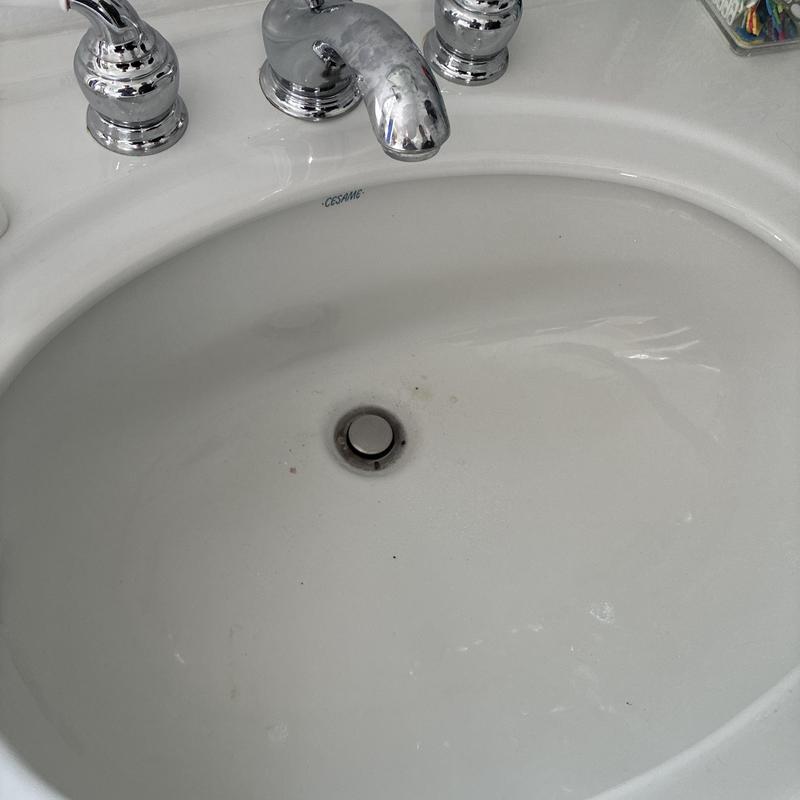 Bathroom sink drain with chrome faucet and handles