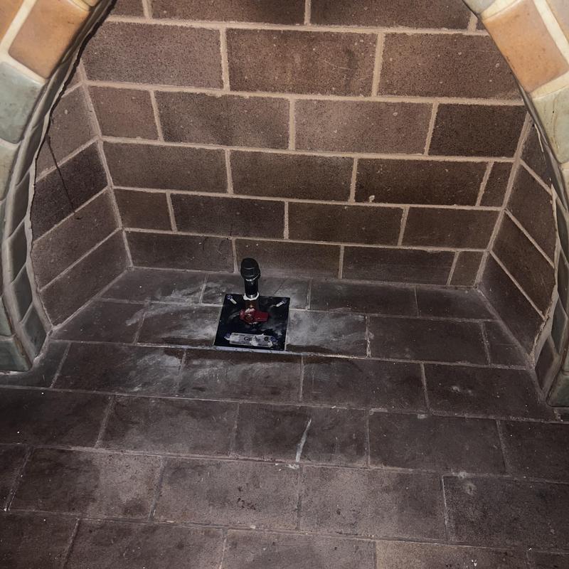 Gas valve inside brick fireplace installation site