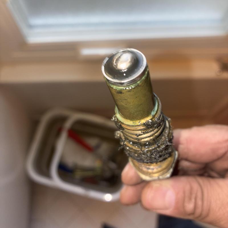 Shower faucet stem with worn washers in hand